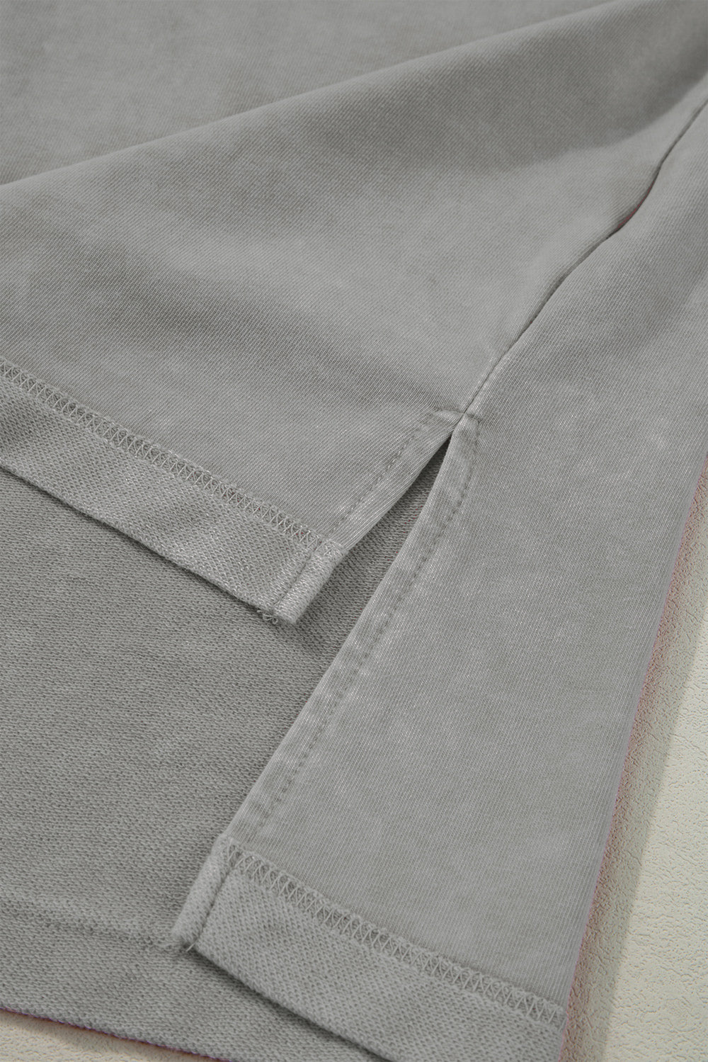 Gray acid wash tee with side slits and layered sleeves detail
