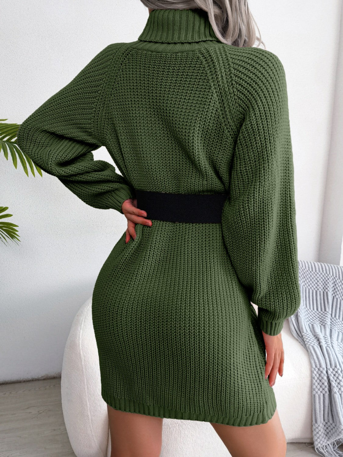Dark green ribbed knit turtleneck sweater dress with balloon sleeves and black belt