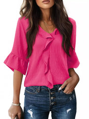 Pink maternity shirt with cascading ruffles, V-neck, and 3/4 bell sleeves.