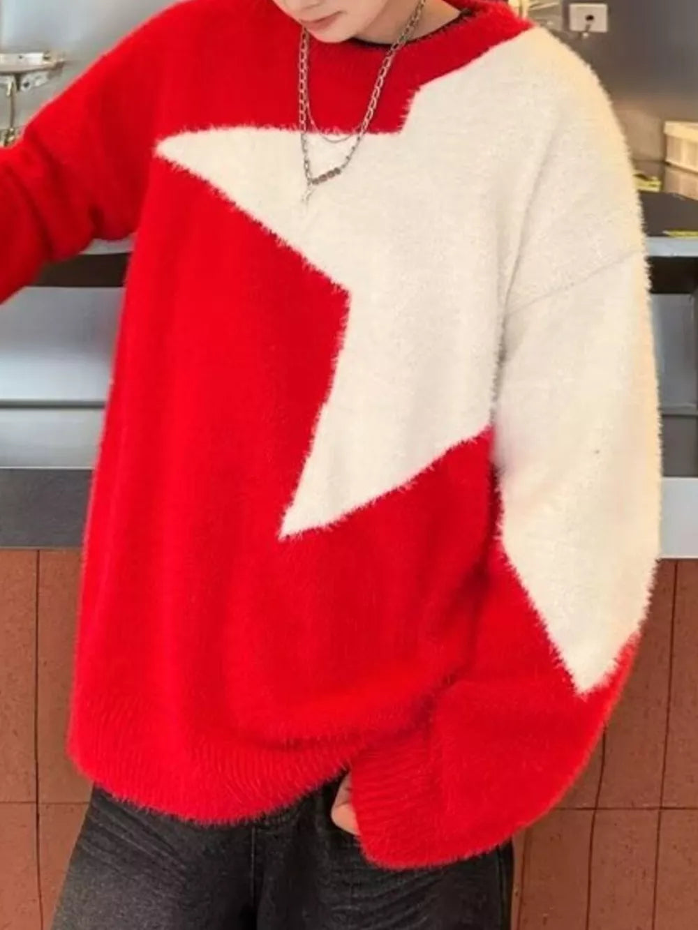 Red fuzzy knit sweater with white star pattern, crew neck, long sleeves.