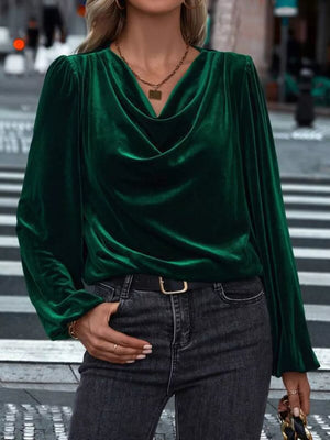 Dark green velvet cowl neck blouse with long sleeves and puffed shoulders.