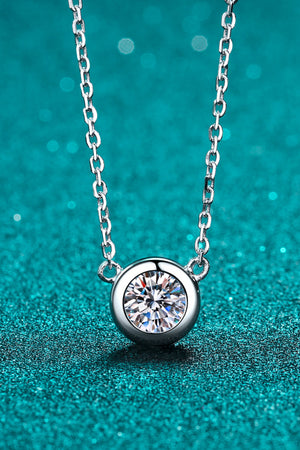 Solitaire bezel-set diamond necklace in silver with a delicate chain.