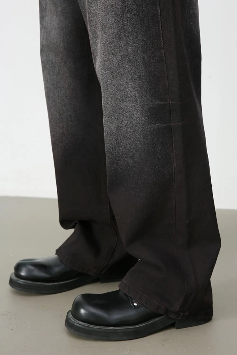 Faded dark wide-leg denim trousers with a relaxed fit.