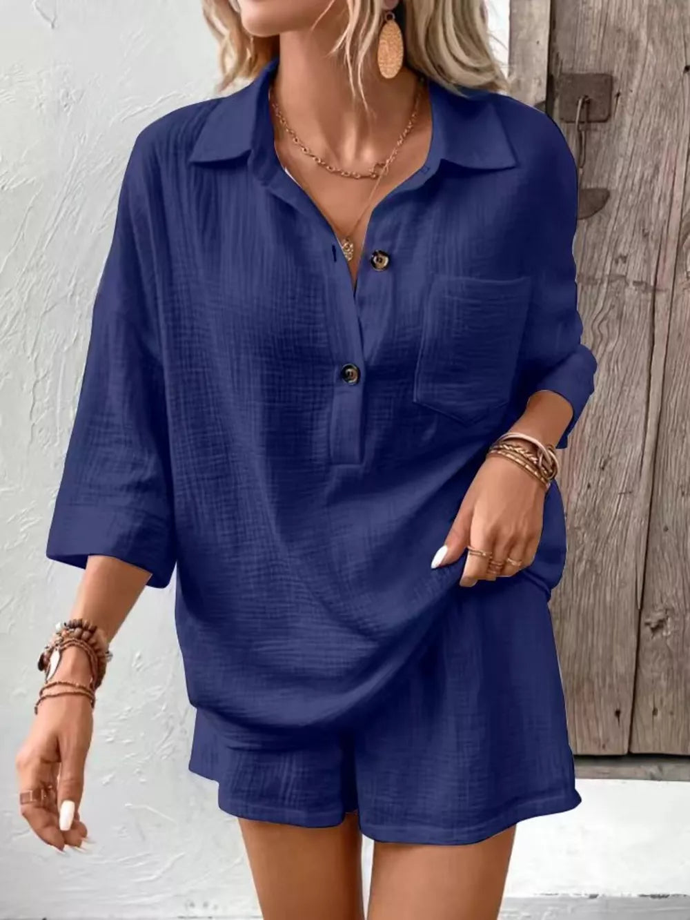 Navy cotton two-piece set with buttoned collared shirt and shorts.