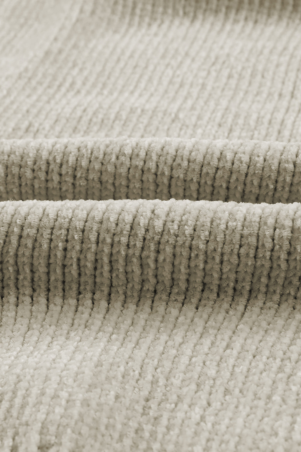 Plush pocket cardigan in khaki with deep V-neck and ribbed texture.