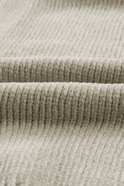 Plush pocket cardigan in khaki with deep V-neck and ribbed texture.