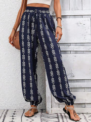 Dark Blue gathered ankle trousers with white leaf print, drawstring waist, and elastic cuffs.