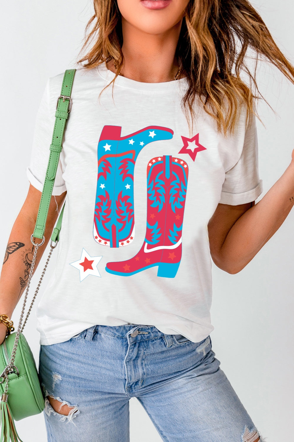 White t-shirt with red and blue boot graphic and stars.