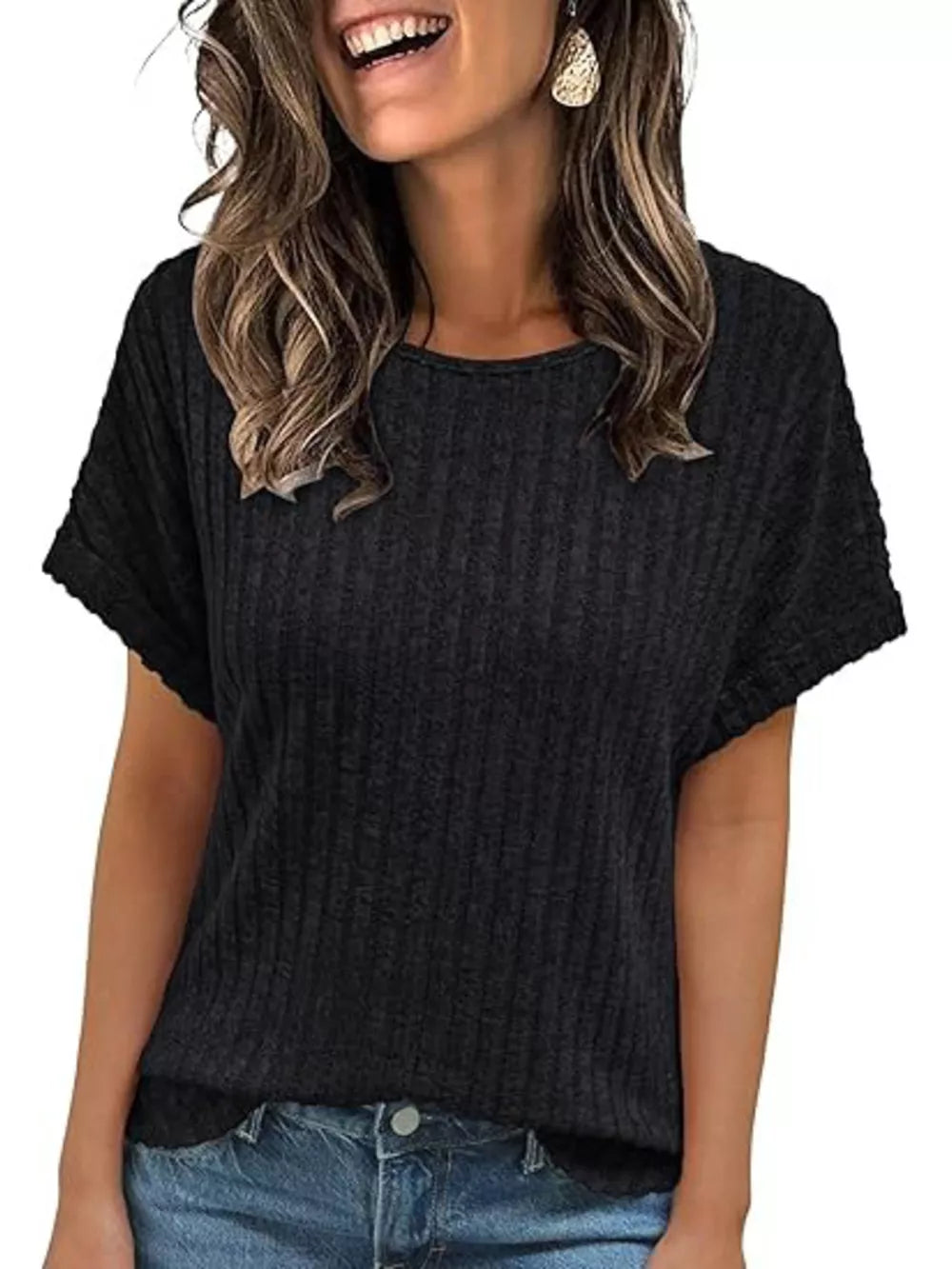 Black ribbed knit t-shirt with short sleeves and a crew neck, styled with jeans.