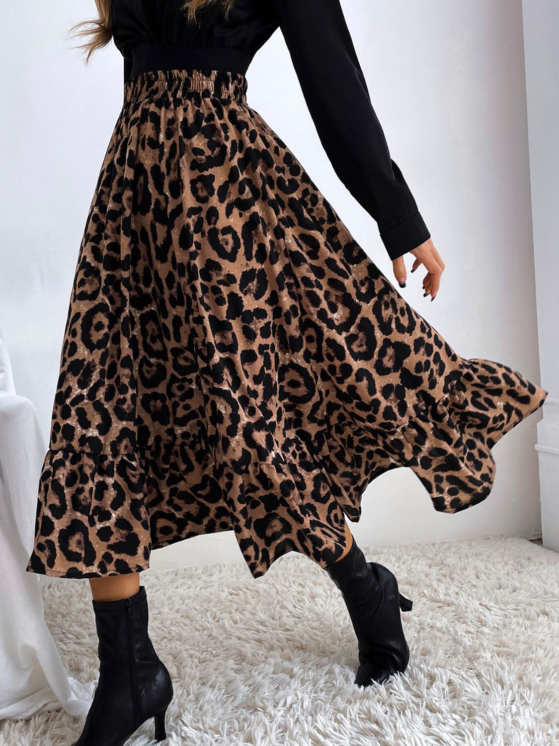 Leopard print midi skirt with tiered ruffles and a flowy silhouette.