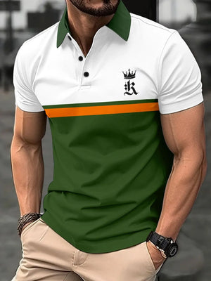 Colorblock polo shirt with crown graphic, white top, orange stripe, green bottom, green collar.