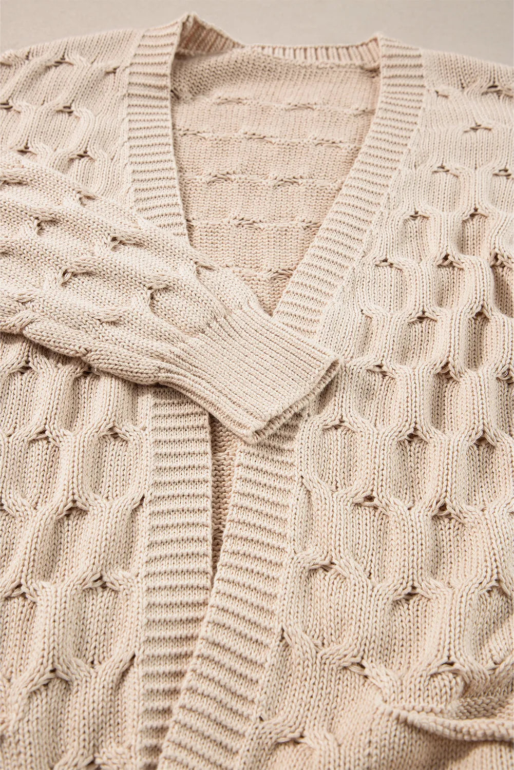 Dust Storm textured open knit cardigan with cable details and ribbed trim.