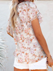 Floral print v-neck blouse with flutter sleeves and tie detail, white with pink and orange flowers