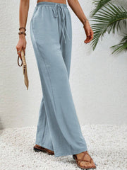 Light Blue textured palazzo trousers with drawstring waist and wide legs.