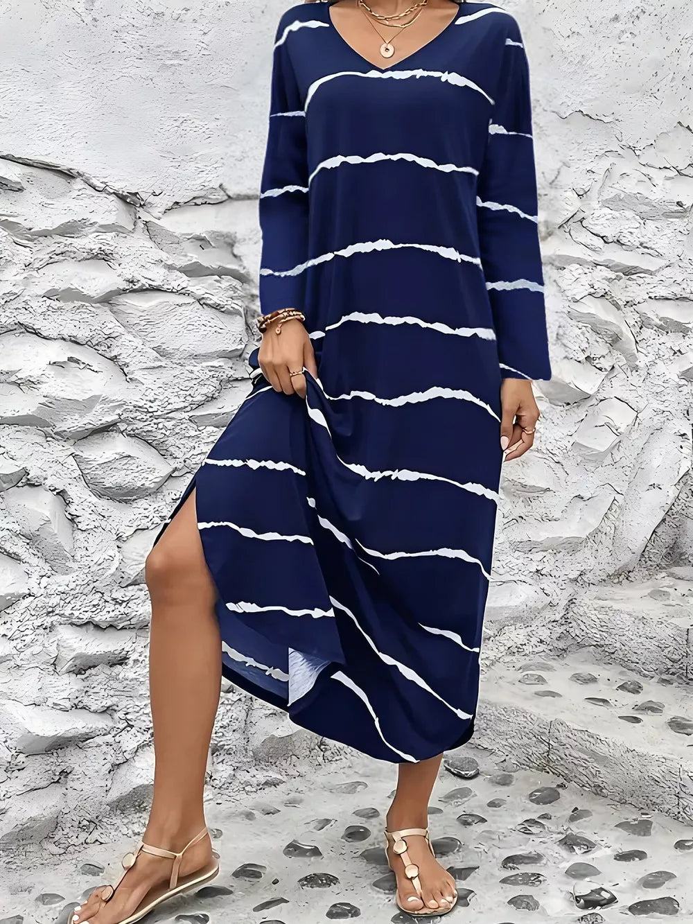 Navy abstract striped v-neck maxi dress with long sleeves and a side slit.