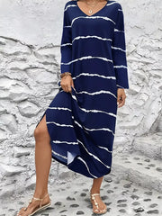 Navy abstract striped v-neck maxi dress with long sleeves and a side slit.
