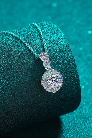 Halo moissanite pendant necklace in sterling silver with a delicate chain and sparkling halo design.
