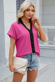 Hot Pink perforated panel polo top with black trim and short sleeves.