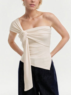 Beige asymmetrical knot detail t-shirt with a cropped cut and one-shoulder design.