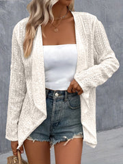 White open-weave draped front cardigan with eyelet detail and long sleeves.