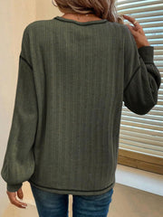 Moss ribbed knit sweater with contrast stitching and balloon sleeves.