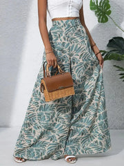 Palazzo trousers in green tropical leaf print, 100% polyester, with a wide leg cut.