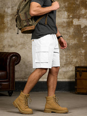 White cargo shorts with drawstring waist and dual front pockets, styled with a backpack.