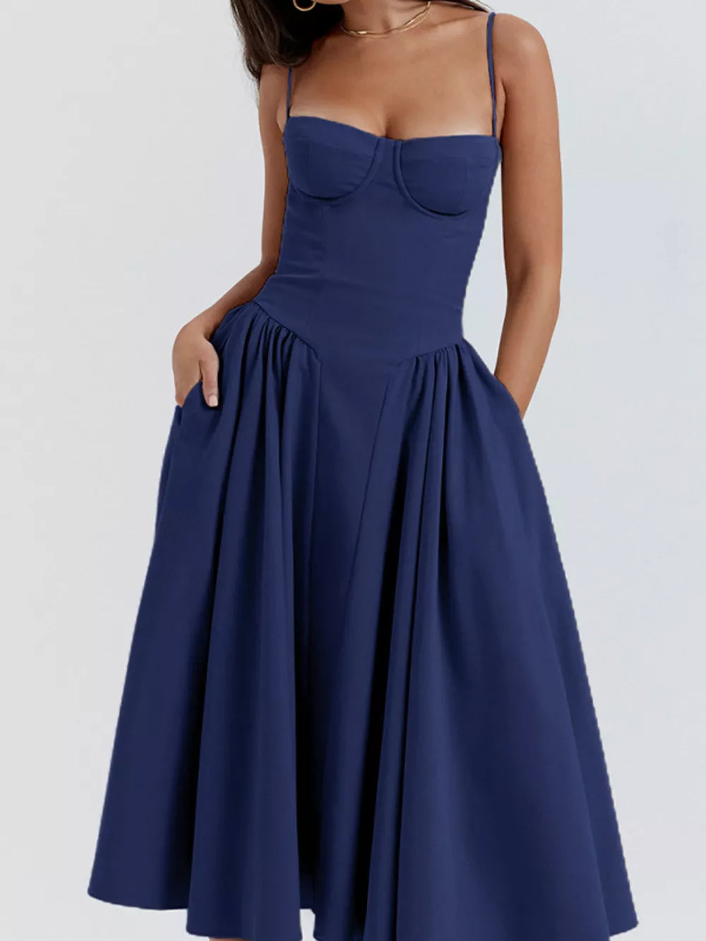 Dark blue midi dress with sweetheart neckline, spaghetti straps, and pockets.