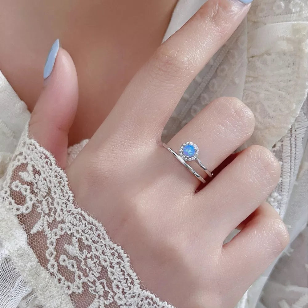 Iridescent opal halo ring on a double band in 925 sterling silver.