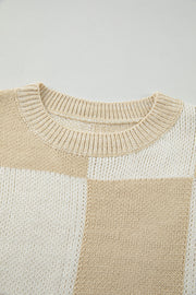 Beige and cream colorblock checkerboard knit sweater with crew neck.