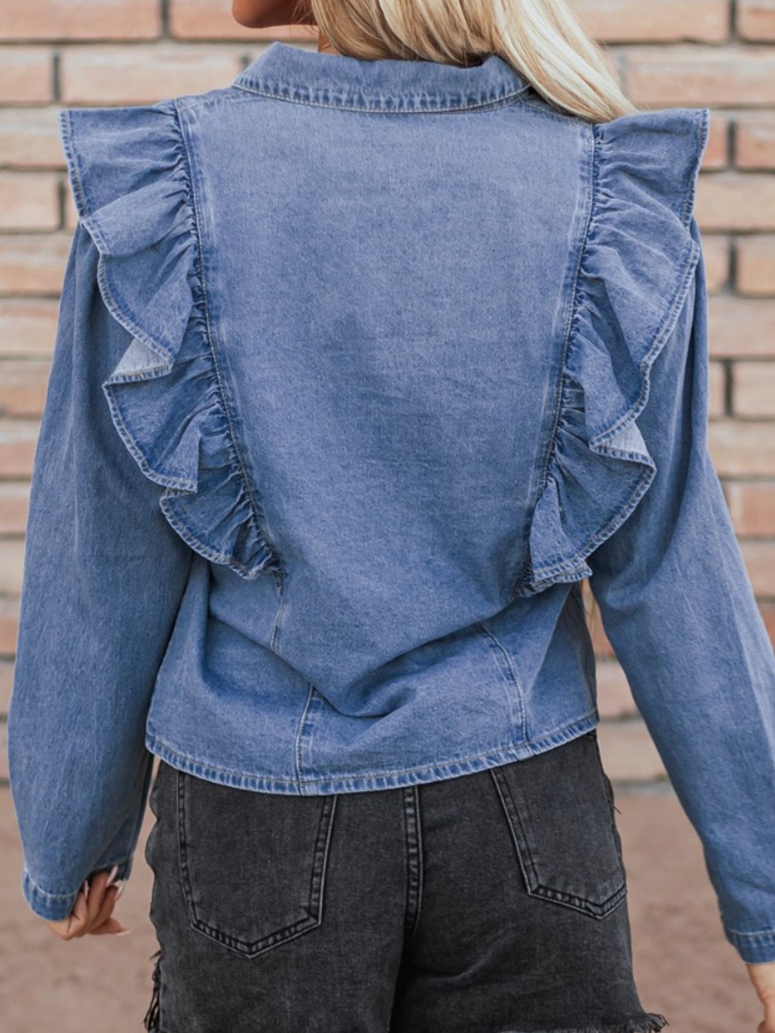 Denim ruffle yoke shirt in medium wash cotton with a collared neckline.