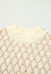 Cream diamond knit sweater with mock neck and ribbed trim.