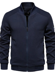 Navy textured knit bomber jacket with zip front and ribbed cuffs.