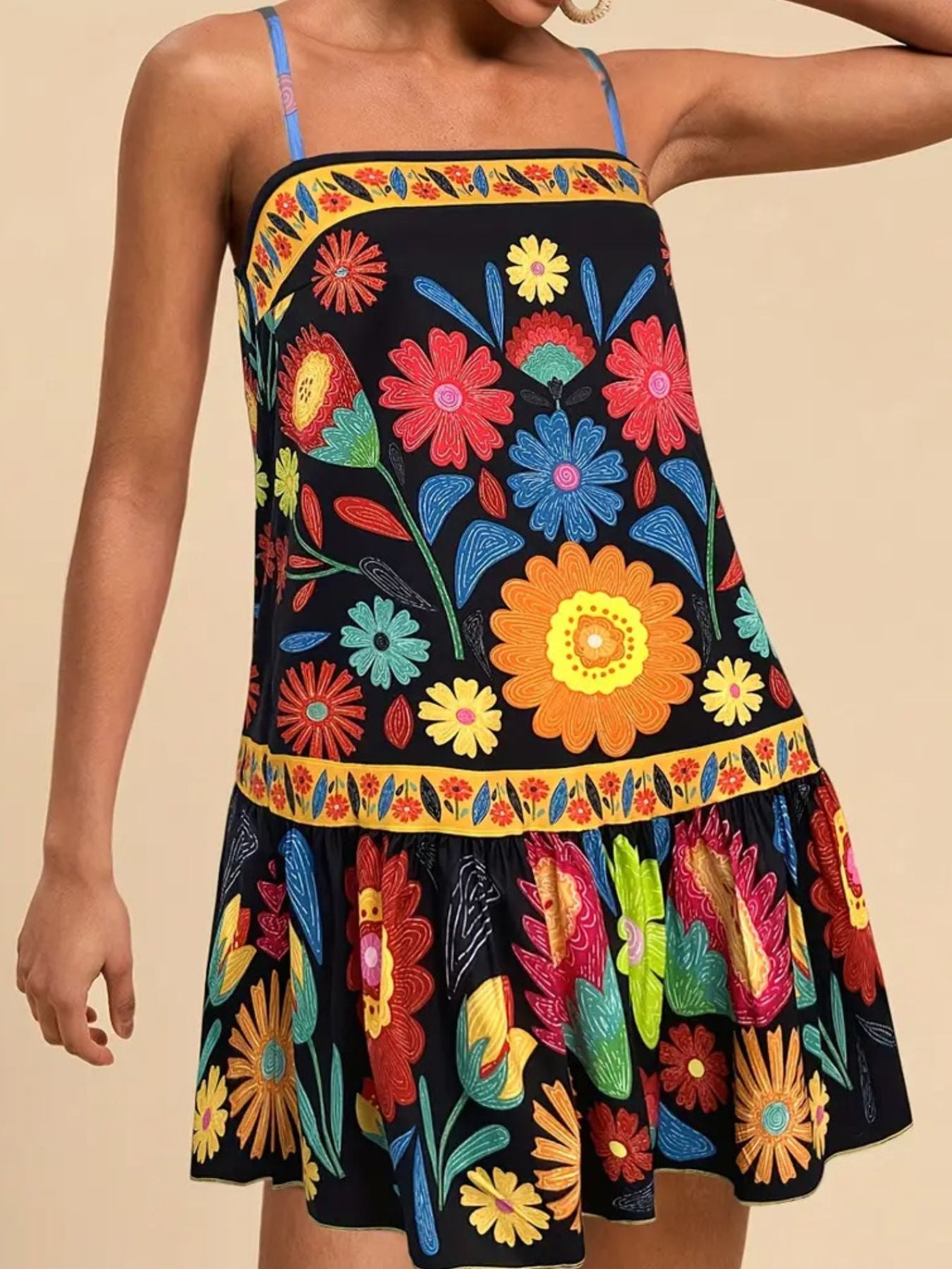 Black mini dress with vibrant floral print, square neck, and ruffled hem.
