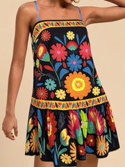 Black mini dress with vibrant floral print, square neck, and ruffled hem.