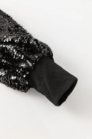 Black sequin sleeve ribbed knit top with waffle knit cuff detail.