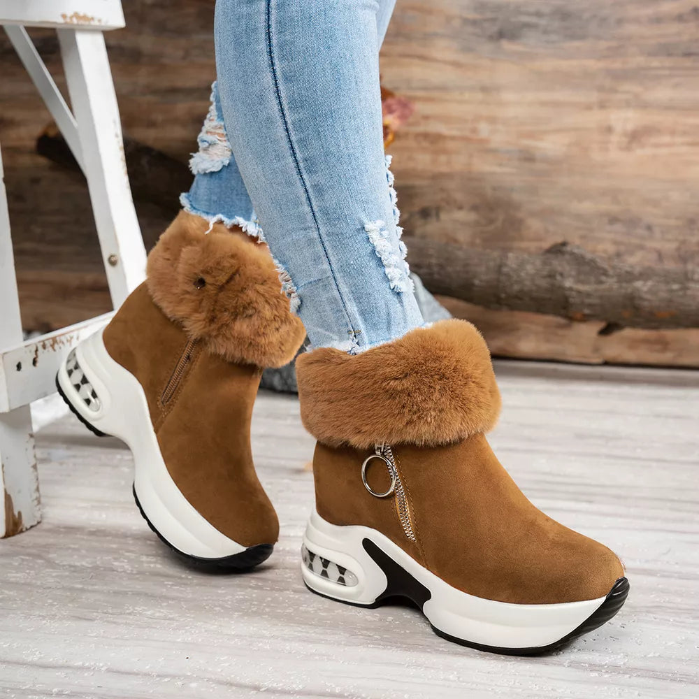 Brown plush ankle boots with side zipper and fur trim, featuring a chunky white sole.