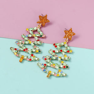 Festive crystal tree dangle earrings with orange star tops and colorful gemstone accents.