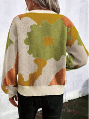 Abstract floral knit sweater with round neck in beige, green, orange, and yellow.