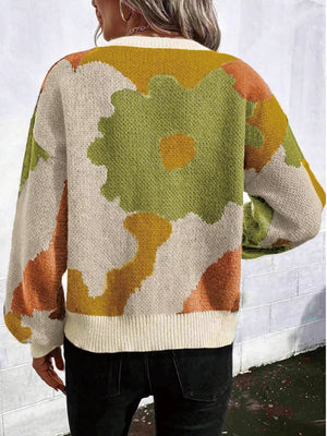 Abstract floral knit sweater with round neck in beige, green, orange, and yellow.