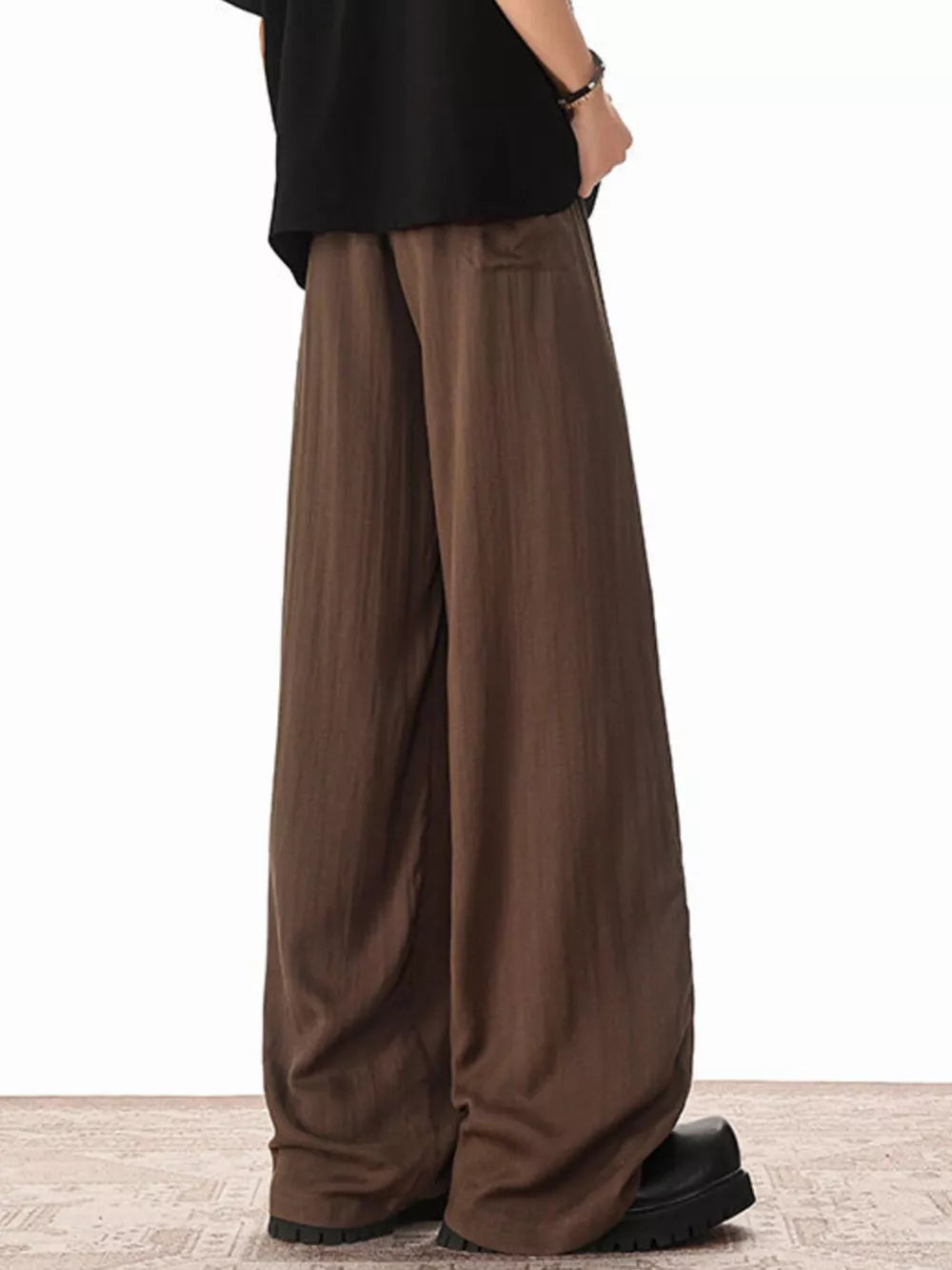 Brown relaxed fit drawstring sweatpants with vertical stripe texture.