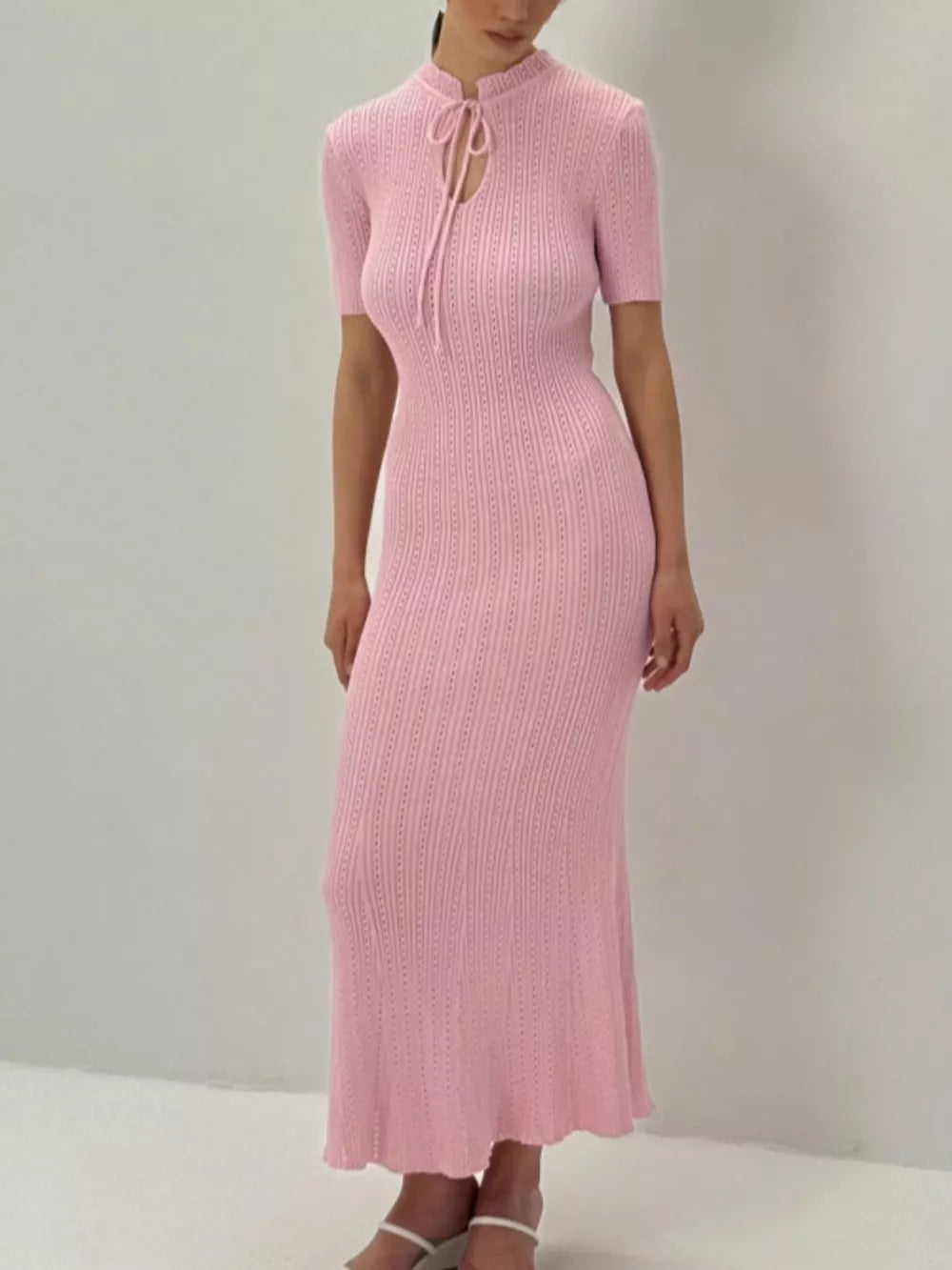 Blush pink knitted mermaid dress with tie neckline and short sleeves.