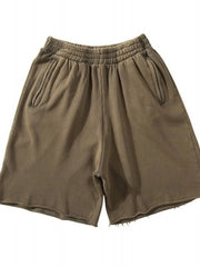 Olive relaxed fit shorts with raw hem and elastic waistband.