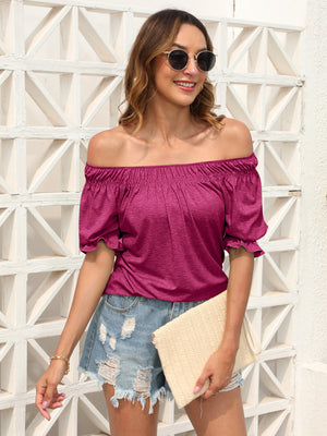 Off-shoulder ruffled sleeve blouse in hot pink with gathered neckline and short puff sleeves.
