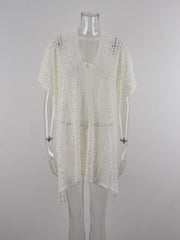 White open-knit V-neck beach cover-up with short sleeves and a tasseled hem.
