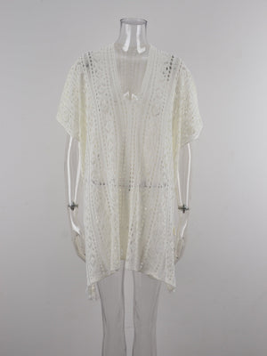 White open-knit V-neck beach cover-up with short sleeves and a tasseled hem.