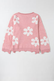 Blush pink knit sweater with white floral pattern and pearl embellishments.