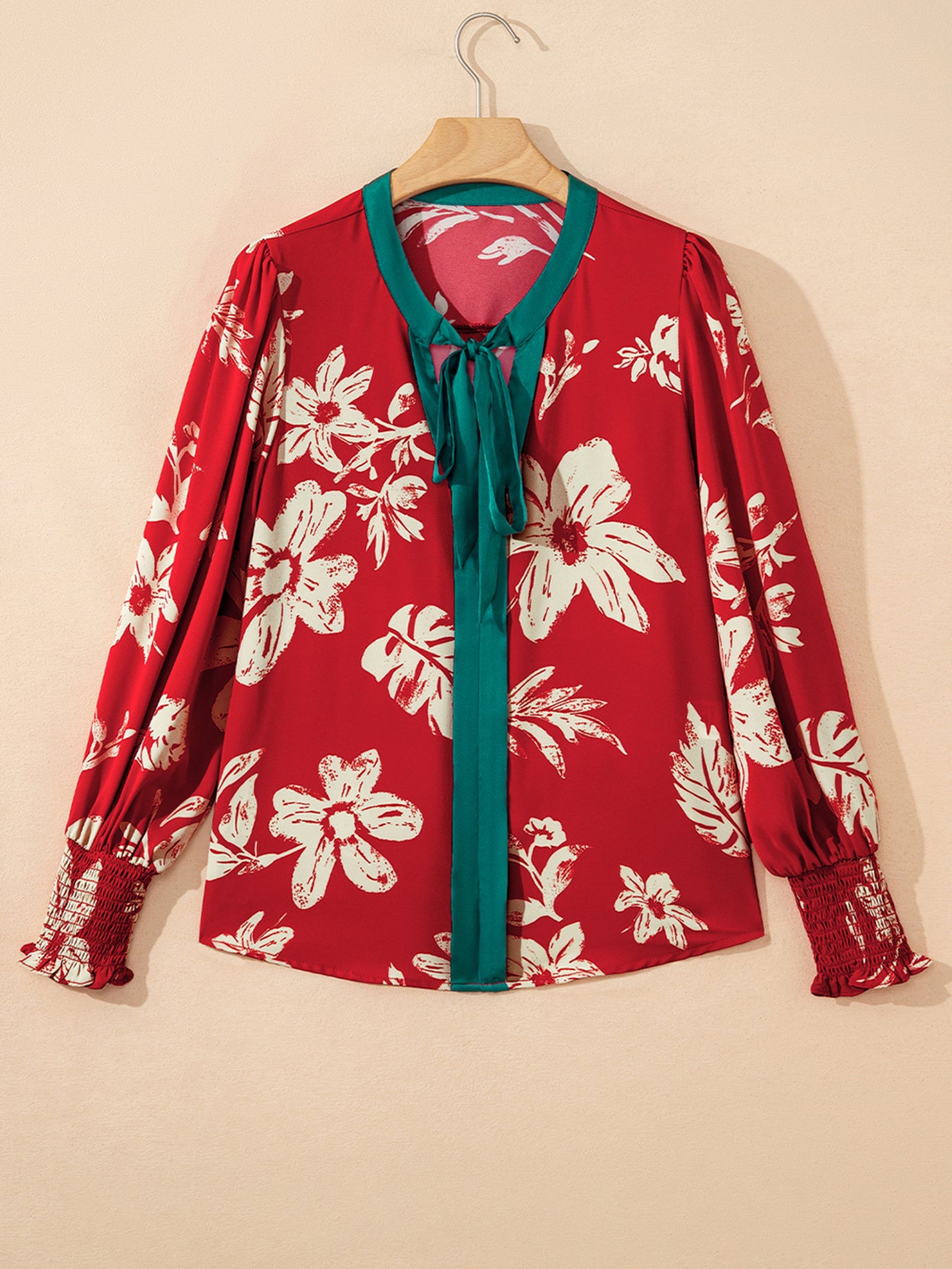 Red floral print blouse with bow tie detail and smocked cuffs