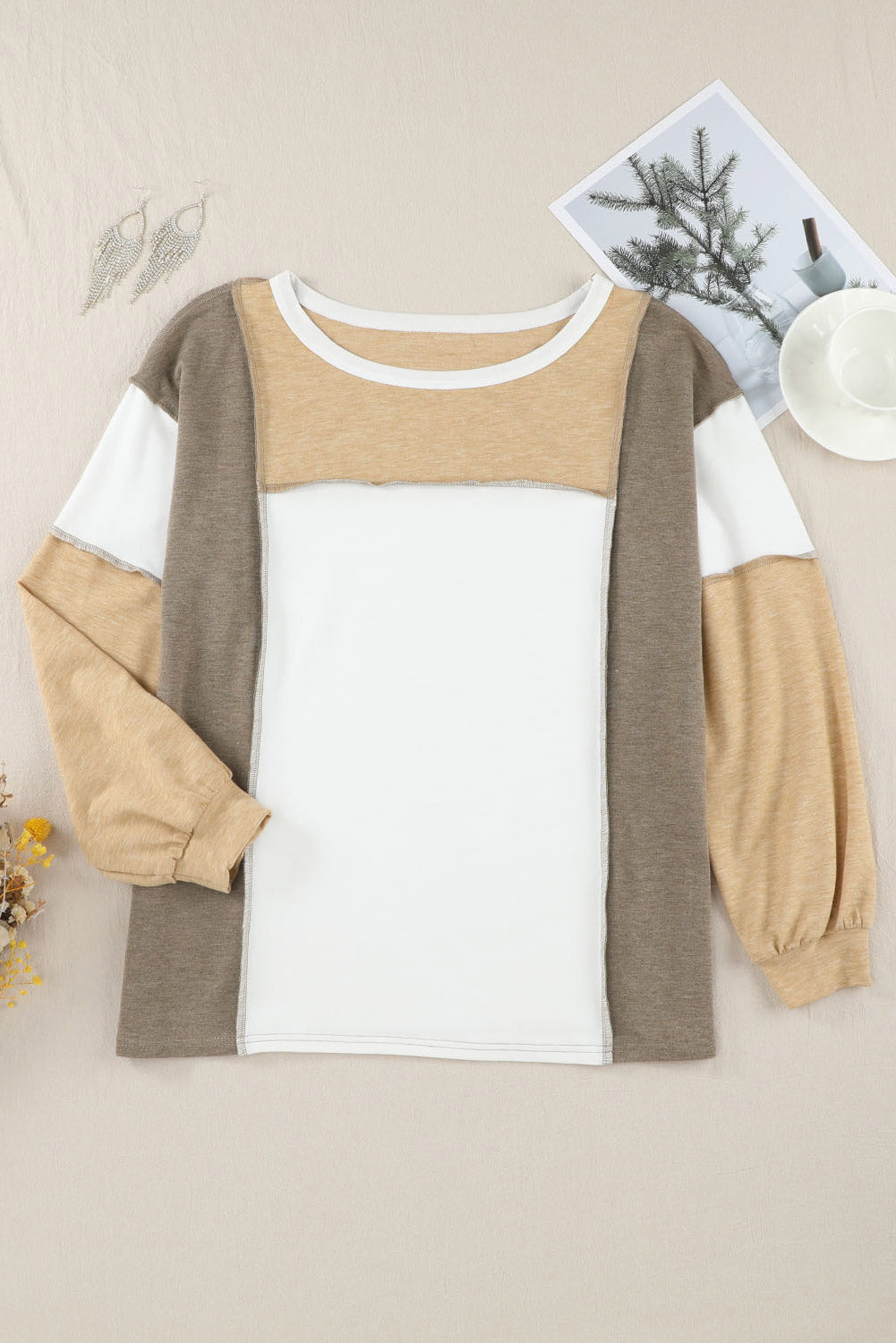 Colorblock slouchy knit top in tan with seam details and long sleeves.