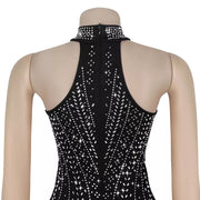 Black halter neck romper with rhinestone embellishments and a high neckline.